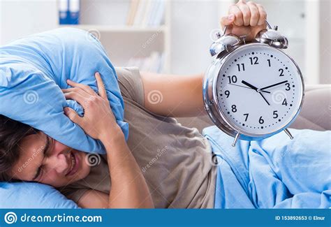 Man Having Trouble Waking Up With Alarm Clock Obraz Stock Obraz