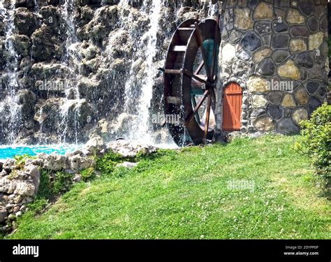 Public Resting Place Working Watermill Wheel With Falling Water Stock