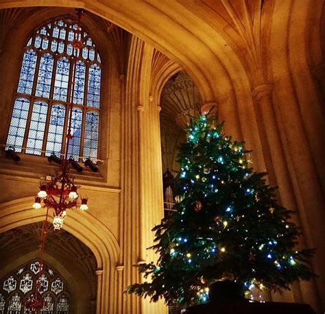 A Lit Christmas Tree In The Middle Of A Cathedral