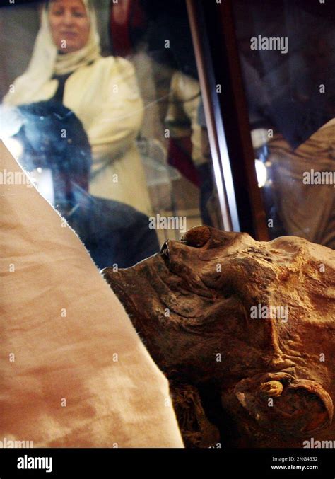 An Egyptian Woman Looks At The Mummy Of Pharaoh Queen Hatshepsut Displayed At The Egyptian