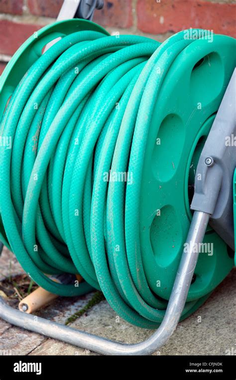Hose Pipe On A Reel In Garden Laying Dormant With The Hosepipe Ban In