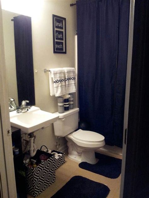 White tile on the walls widens the space visually, while the black and white tiles on the floor harmonize the rest of the room. My College Apartment bathroom. Black and white with grey ...
