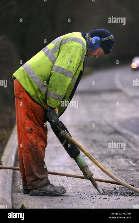 Road Worker Digging Up Tarmac Stock Photo Alamy
