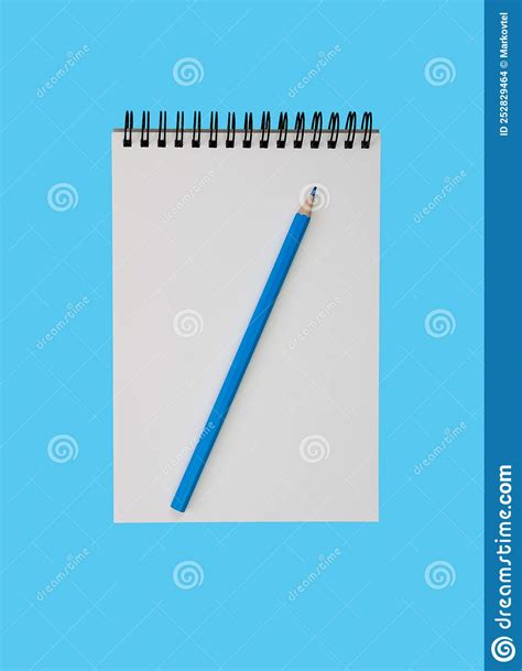 A Blank Notebook And A Blue Pencil On A Blue Background Flatlay