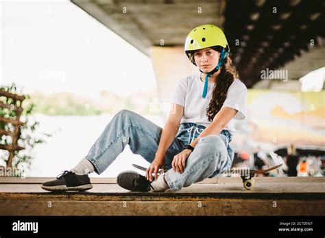 Schoolgirl After Lessons At Skateboarding Practice In Outdoor Skate