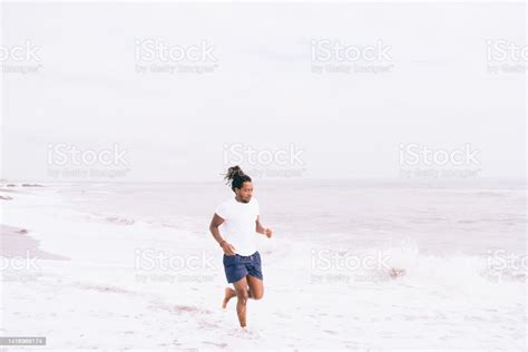 Black Man Jogging On Sandy Beach Stock Photo Download Image Now 40