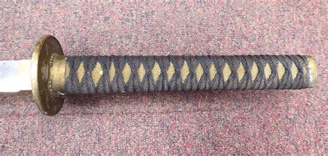 A Japanese Katana With A Simulated Shagreen Covered And Woven Fabric