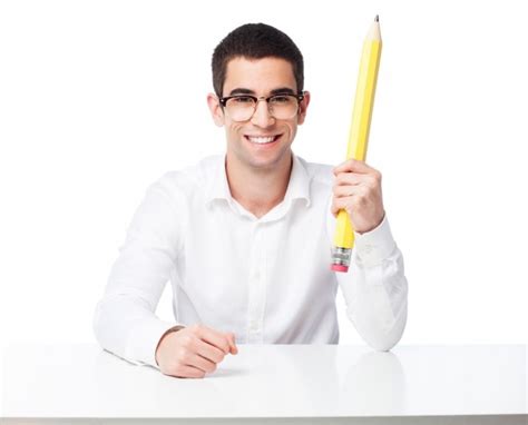 Happy Man Sitting And Holding A Big Pencil Photo Free Download