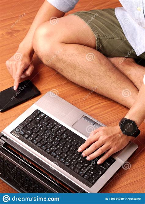 Closeup Of A Man Sitting Typing On Keybord Of His Laptop And His