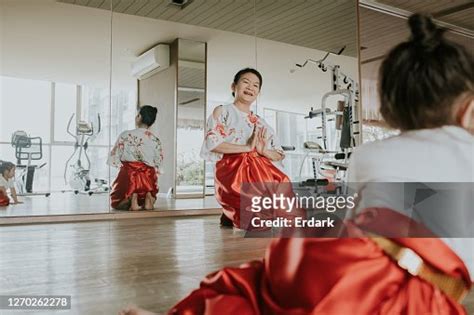 Senior Woman Teaching Thai Traditional Dancing To Cute Girlstock Photo