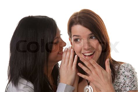 Two Young Women Whisper To Each Other Stock Image Colourbox
