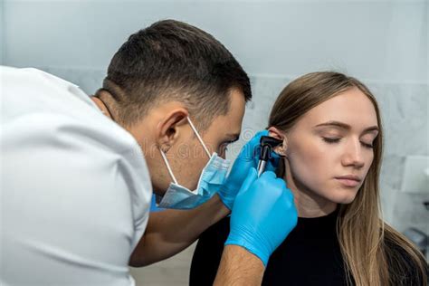 Ent Doctor Examines The Ear With An Otoscope Of A Female Patient In The