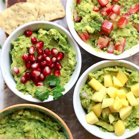 Four Bowls Filled With Guacamole And Fruit