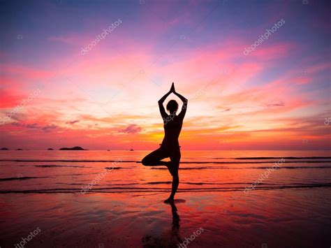Silhouette Of A Beautiful Yoga Woman In The Evening On The