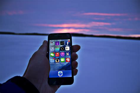 Hand Holding Phone At Snowy Sunset Image Free Stock Photo Public