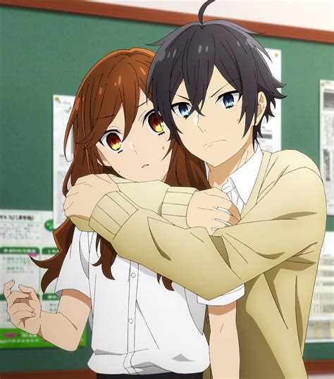 Two Anime Characters Hugging Each Other In Front Of A Green Board With