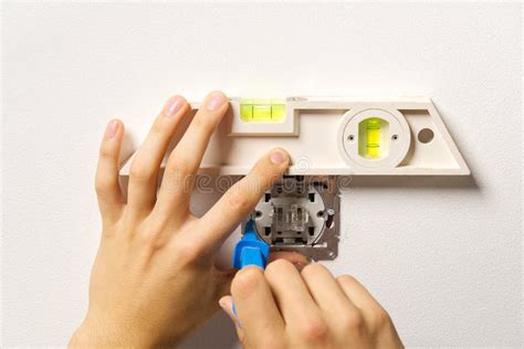 Electrician Installing Light Switch On Painted Wall With Screwdriver