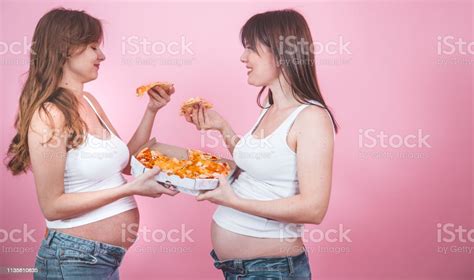 Nutrition Concept Pregnant Women Eating Pizza On A Pink Background