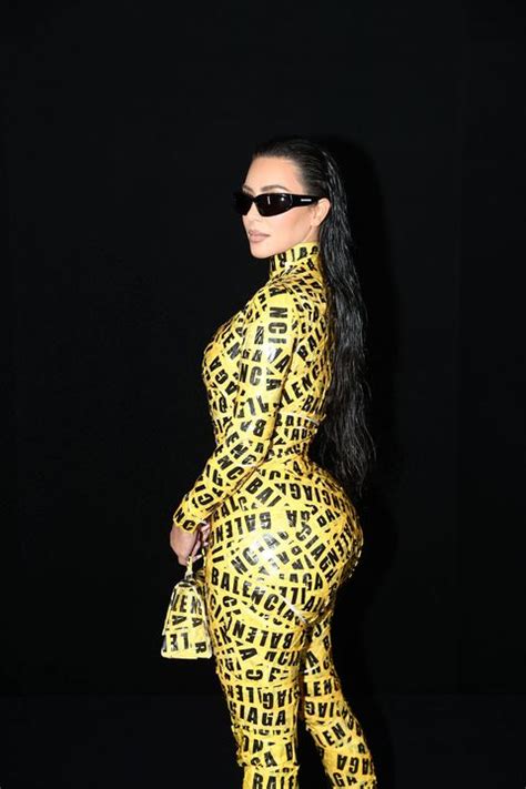 kim kardashian wears a balenciaga caution tape catsuit
