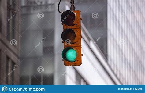 Green Traffic Lights For Cars Blur Office Buildings Background Stock