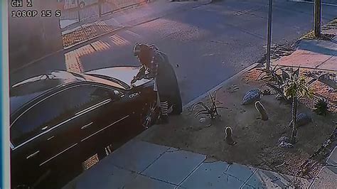 Video Security Camera Catches Woman Vandalizing Car In Los Angeles While Others Stopped And