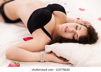 Attractive Sexual Brunette Sleeping On Bed Stock Photo