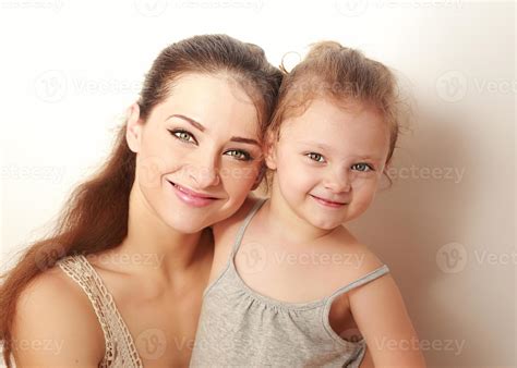 Beautiful Smiling Mother And Small Happy Daughter Cuddling