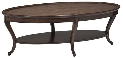 The modern steel base and reclaimed french oak shelf below makes for the perfect landing spot for all of your beloved design books. Sleek oval cocktail table from our modern Dakota collection