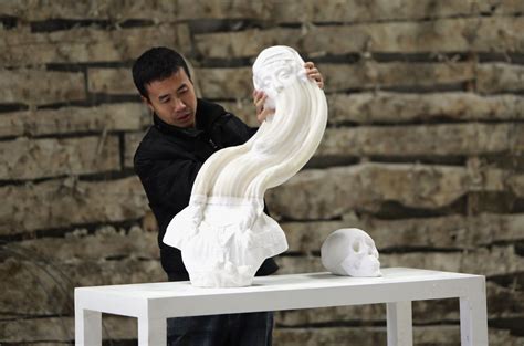 Chinese Artist Li Hongbo Stretches A Paper Sculpture Work On The