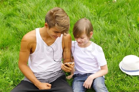 Older And Younger Brother Sitting On Stock Image Colourbox