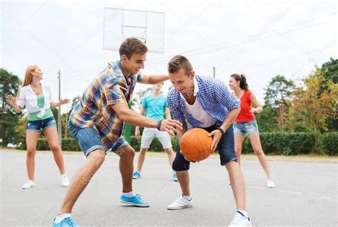 Group Of Happy Teenagers Playing Basketball — Stock Photo © Syda