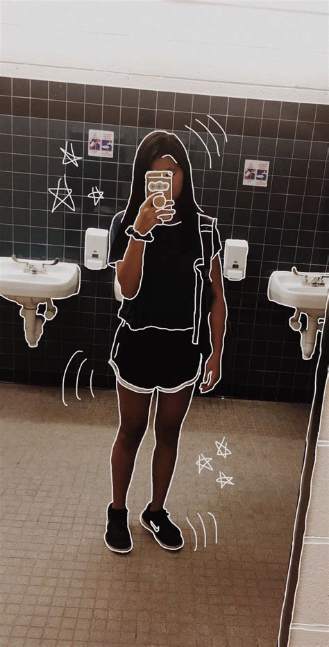 A Woman Taking A Selfie In A Public Restroom