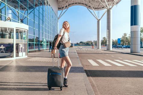 Young Tourist Woman With Baggage Near International Airport For Journey