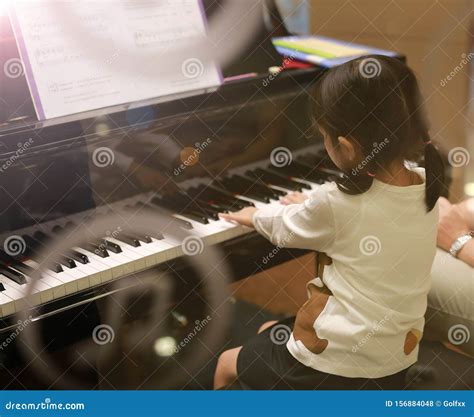 Child Girl Playing Piano View From Outside Glass Stock Photo Image