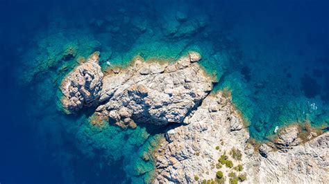Download Wallpaper 3840x2160 Rocks Island Sea Water Aerial View 4k