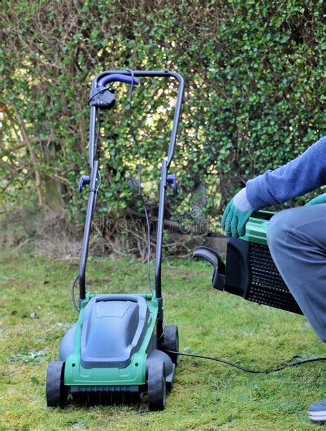 Removing Grass Basket From A Electric Lawn Mower Machine Stock Photo