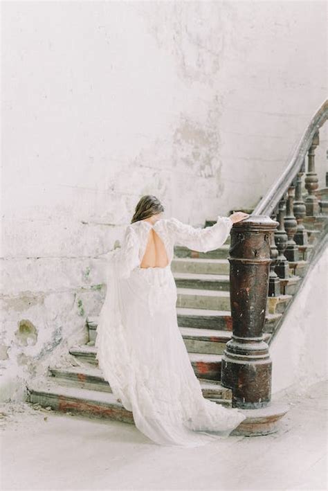 A Woman In Wedding Dress Walking Up A Staircase · Free Stock Photo