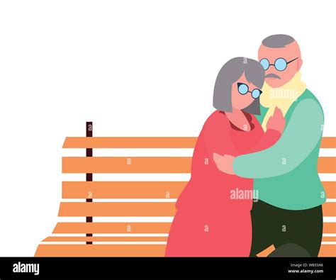 Grandfather And Grandmother Sitting On A Bench Hugging Happy