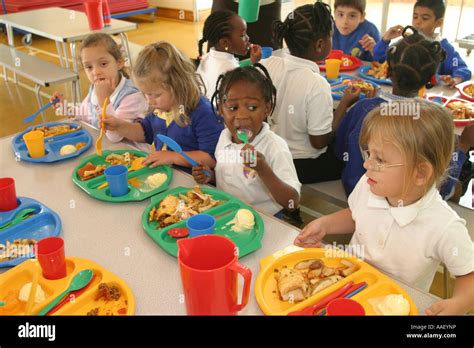 Primary School Canteen With Children Eating Lunch Stock Photo Royalty