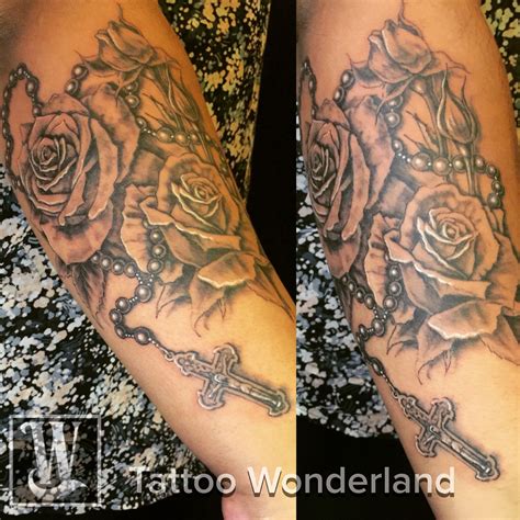 A symbol of love, but especially of a love that is pure. #Rose & #rosary #tattoo @timur_zakiev @tattoowonderland # ...