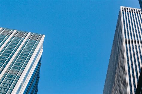 Contemporary Skyscrapers Under Cloudless Sunny Blue Sky · Free Stock Photo