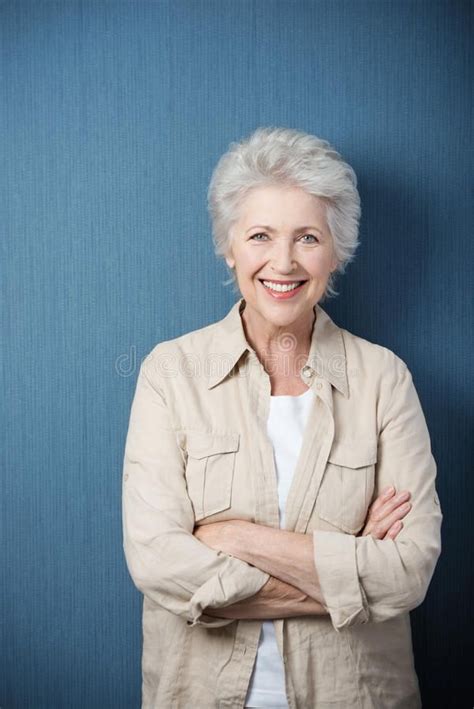 Stylish Modern Elderly Woman Standing Smiling At The Camera With