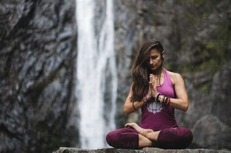 Italy Lecco Woman Doing Meditation Near A Waterfall Stock Photo