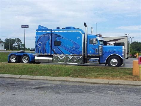 A Blue Semi Truck Parked On The Side Of The Road