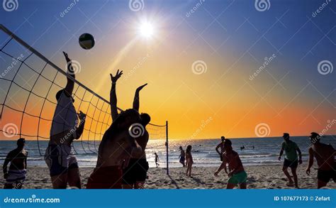 Group Of Young Girls Playing Beach Volleyball During Sunset Editorial