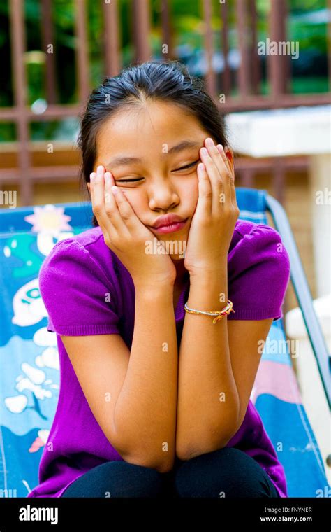 Young Girl Sitting Hands On Chin Look Bored Stock Photo Alamy