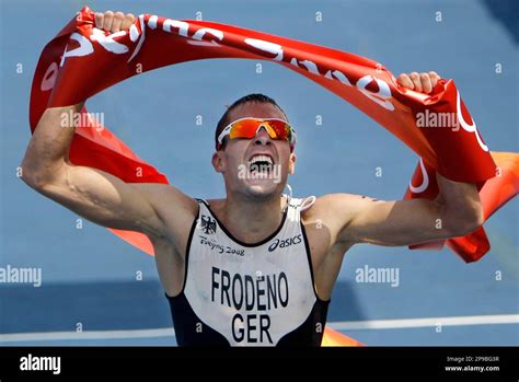 File Germanys Jan Frodeno Crosses The Finish Line To Win The
