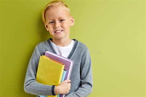 Cute Intelligent Child Boy Stands With Books Before School Stock Photo