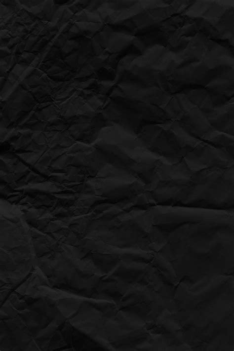 A Black Paper Textured Background That Looks Like It Is Crinkled Or