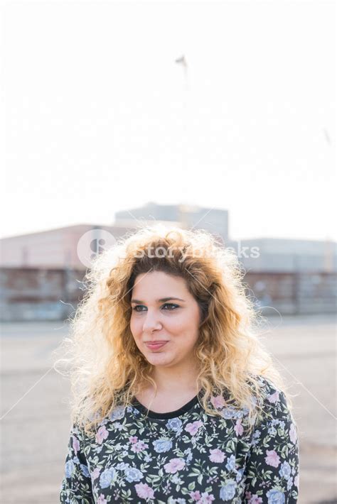 Half Length Of Young Curly Blonde Hair Caucasian Girl Posing In The